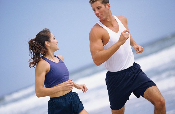 A person walking briskly outdoors for cardiovascular exercise