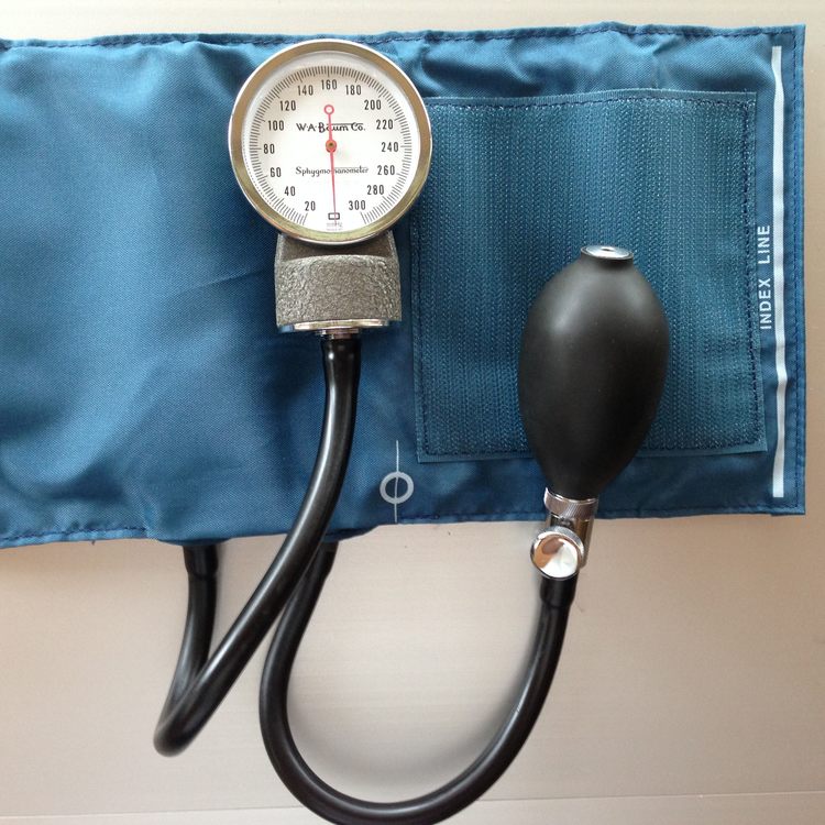 A blood pressure cuff and monitor being used to take a reading